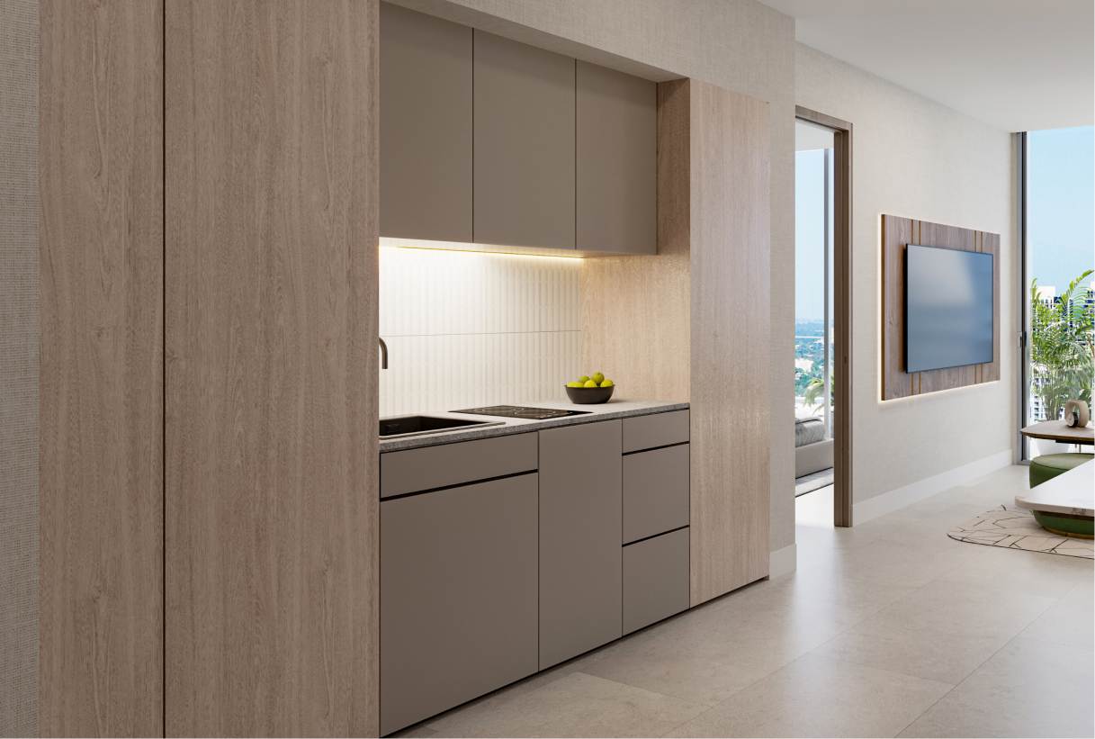 A modern and minimalist kitchen featuring sleek cabinetry in neutral tones, with integrated appliances and a subtle backsplash.